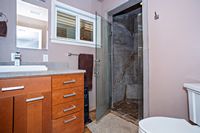 Custom stone showers, windows toward river